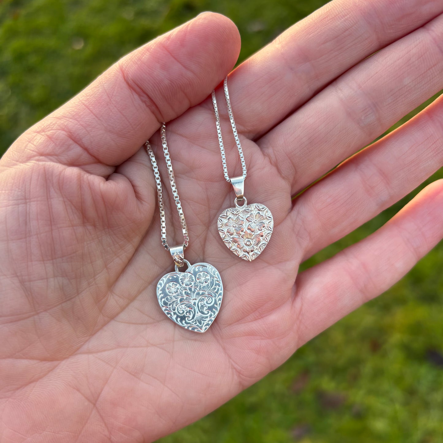 Silver heart pendant with hand engraved flowers