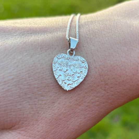 Silver heart pendant with hand engraved flowers