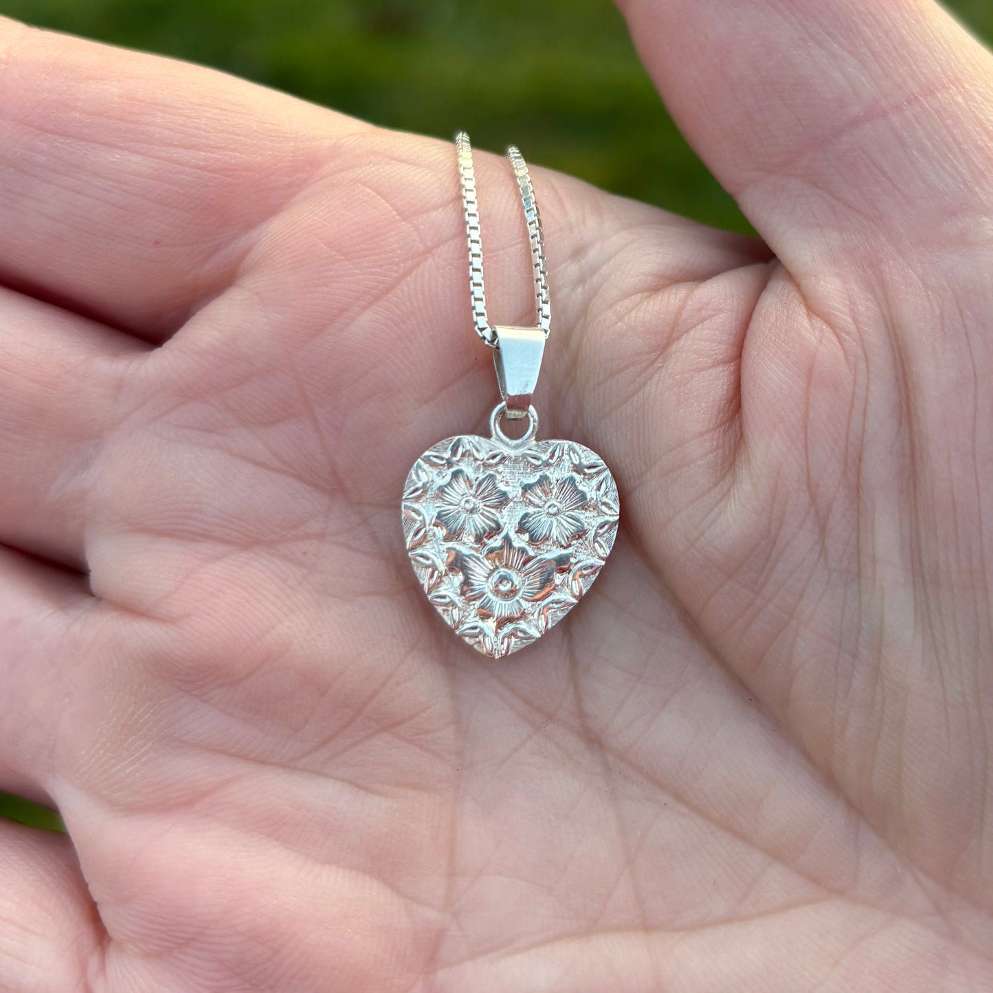 Silver heart pendant with hand engraved flowers