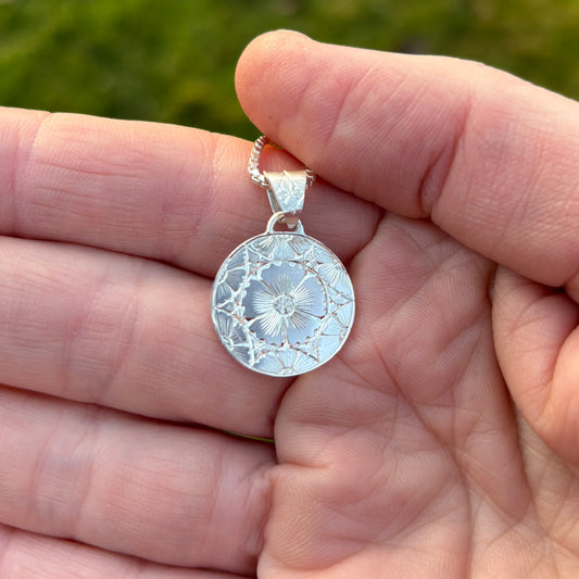 Silver pendant with hand engraved flowers