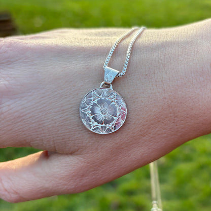 Silver pendant with hand engraved flowers